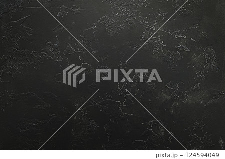 Dark textured surface with abstract markings and subtle rough patterns 124594049