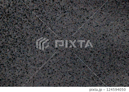 Closeup view of black dotted texture on a dark gray surface background 124594050