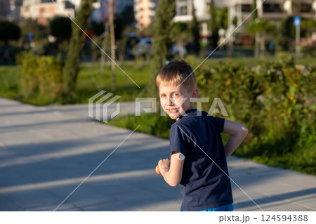 Boy with diabetes riding a scooter, smiling at the camera. Boy with diabetes riding a scooter, smiling at the camera. 124594388