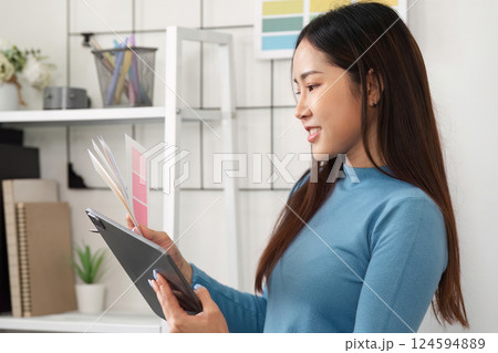 Artistic Color Exploration. A designer thoughtfully reviewing color options with enthusiasm. 124594889
