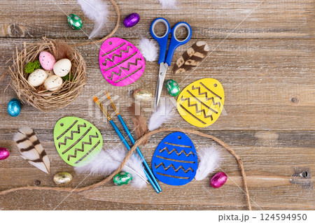 Easter crafting with paintbrushes, scissors, assorted eggs and nest. Easter crafting with paintbrushes, scissors, assorted eggs and nest. 124594950