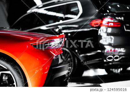 Vibrant Red Sports Car Showcased with Stunning Design at Auto Event, Bold Crimson Performance Vehicle Displayed with Sleek Style at Car Exhibition 124595016