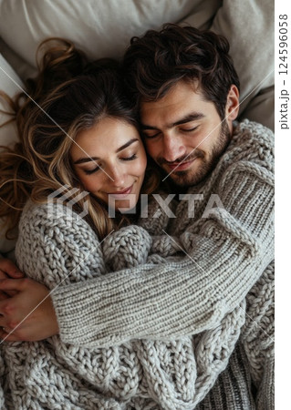 Cozy winter embrace: warmth and love in knitted sweaters - perfect for lifestyle and relationships themes 124596058