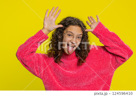 Cheerful funny bully girl showing tongue making silly faces, fooling around joking teasing Cheerful funny bully girl showing tongue making silly faces, fooling around joking teasing 124596410