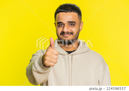 Indian man raises thumbs up agrees or gives positive reply recommends advertisement likes good idea 124596557