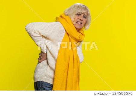 Senior old woman touching injured sore back, backache, suffering lower lumbar discomfort muscle pain 124596576