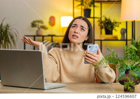 Sad pretty woman use smartphone surprised by bad news, fortune loss, fail, lottery results, deadline 124596607