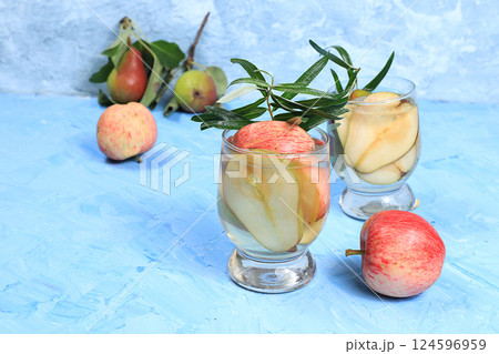 Apple and pear cider, juice or fruit drink and ingredients on a sunny table. The concept of diet and weight loss. Apples help cleanse the body and reduce weight. Healthy eating, selective focus 124596959