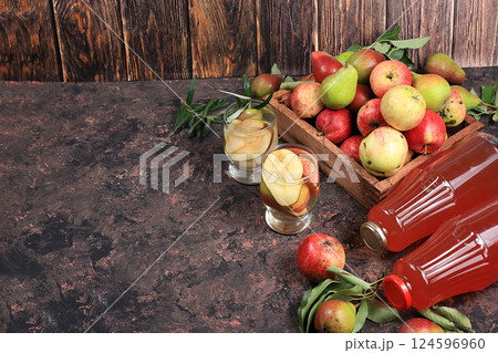 Apple and pear cider, juice or fruit drink and ingredients on a sunny table. The concept of diet and weight loss. Apples help cleanse the body and reduce weight. Healthy eating, selective focus Apple and pear cider, juice or fruit drink and ingredients on a sunny table. The concept of diet and weight loss. Apples help cleanse the body and reduce weight. Healthy eating, selective focus 124596960