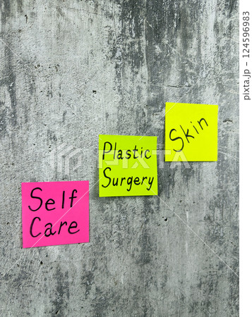 Vertical photo of sticky notes with words reminding about skin care. Use plastic surgery for health and skin improvement. Simple concept of selfcare Vertical photo of sticky notes with words reminding about skin care. Use plastic surgery for health and skin improvement. Simple concept of selfcare 124596983