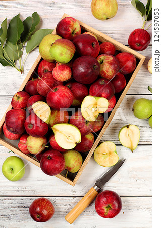Autumn composition of apples in box on sunny wooden table, thanksgiving background, harvest, healthy natural food concept, detox diet and body cleansing, banner on screen, cafe, restaurant, selective 124597053