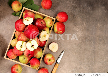 Red apples in a wooden box on an old concrete background, harvesting in the village, healthy natural food concept, shop advertising, cafe business card, selective focus Red apples in a wooden box on an old concrete background, harvesting in the village, healthy natural food concept, shop advertising, cafe business card, selective focus 124597102