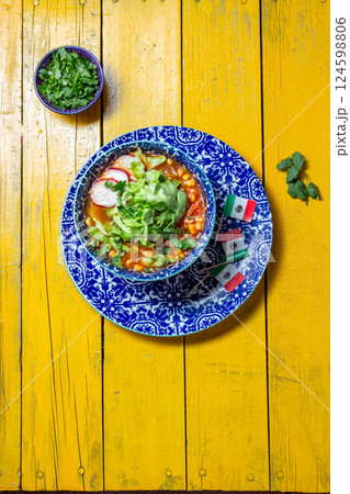 Delicious Pozole soup served in a colorful bowl with fresh toppings for Mexican Independence Day Delicious Pozole soup served in a colorful bowl with fresh toppings for Mexican Independence Day 124598806