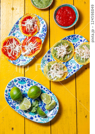 Delicious selection of chalupas featuring fried tortillas and a variety of toppings for a festive celebration Delicious selection of chalupas featuring fried tortillas and a variety of toppings for a festive celebration 124598849