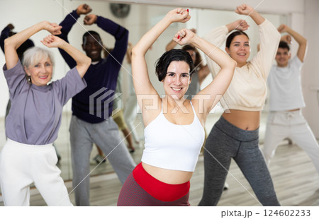 Adult group of people learn the movements of zumba 124602233