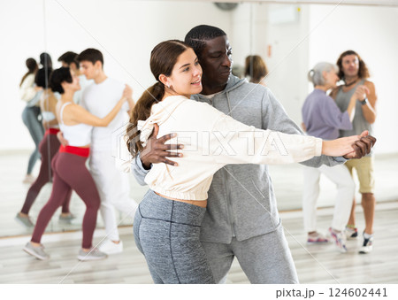 Positive couple of dancers learns a slow foxtrot 124602441