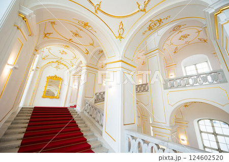 Internal staircase in palace, walls are decorated with gold-colored monograms in Bratislava castle Internal staircase in palace, walls are decorated with gold-colored monograms in Bratislava castle 124602520