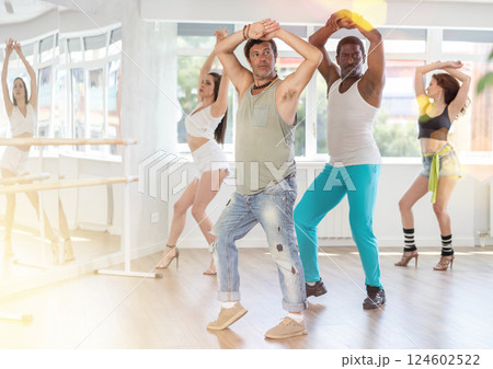 Group of men and women dancing in studio 124602522