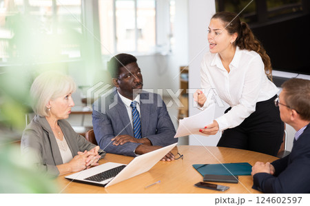 Group of different people arguing at table in office 124602597