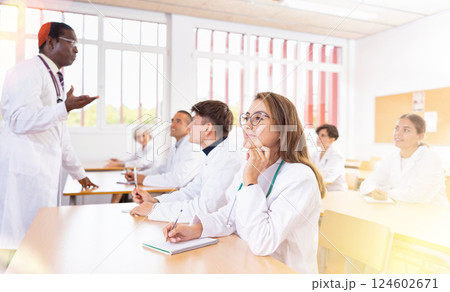 Young latin american woman listening to lecture during medical training Young latin american woman listening to lecture during medical training 124602671