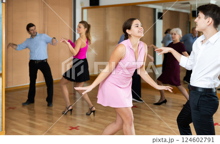 Young pair practicing Latino dance in dance studio Young pair practicing Latino dance in dance studio 124602791