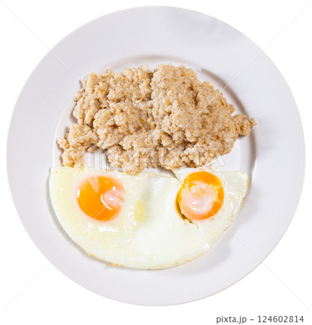 Breakfast with scrambled eggs and oatmeal with butter closeup 124602814