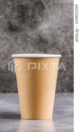 Brown paper cup with customizable logo space on gray background 124603269