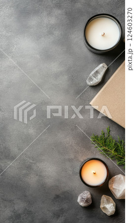 Scented candles and crystals on gray surface create calming atmosphere 124603270