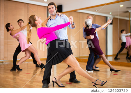 Woman and man dancing slow ballroom dance in choreography studio Woman and man dancing slow ballroom dance in choreography studio 124603729