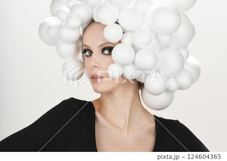 Beauty with White Spheres Headpiece Studio Portrait 124604365