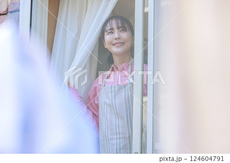 窓を開け外を見る主婦 124604791