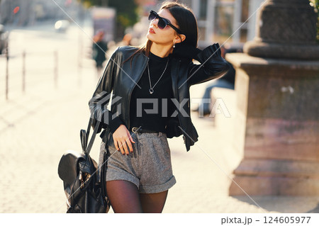 stylish girl walking through the city on a warm sunny autumn day 124605977