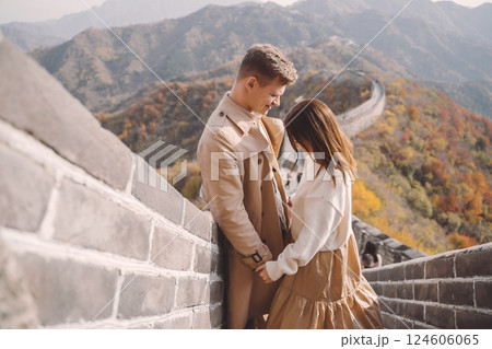 beautiful young couple showing affection on the Great Wall of China. Newly married couple on their honemoon to Great Wall near Beijing China. Stylish couple exploring one of the wonders of the world beautiful young couple showing affection on the Great Wall of China. Newly married couple on their honemoon to Great Wall near Beijing China. Stylish couple exploring one of the wonders of the world 124606065