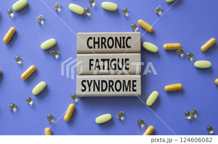 Chronic Fatigue Syndrome symbol. Concept word Chronic Fatigue Syndrome on wooden blocks. Beautiful purple background with pills. Medicine and Chronic Fatigue Syndrome concept. Copy space 124606082