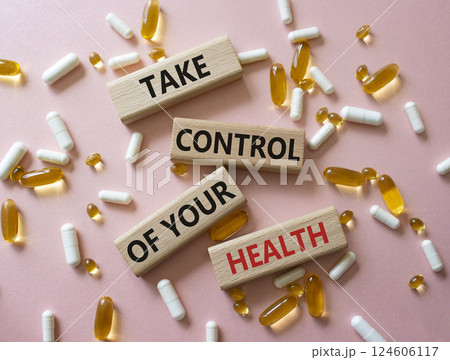 Health symbol. Concept word Take Control of your Health on wooden blocks. Beautiful pink background with pills. Medicine concept. Copy space Health symbol. Concept word Take Control of your Health on wooden blocks. Beautiful pink background with pills. Medicine concept. Copy space 124606117