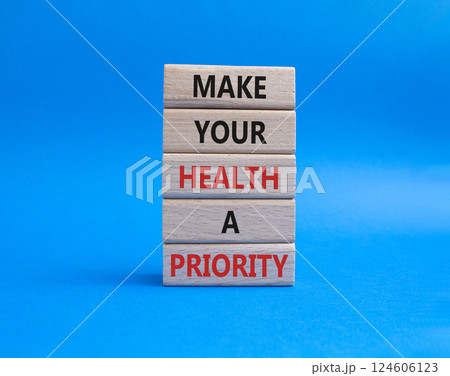 Health symbol. Wooden blocks with words Make your health a Priority. Beautiful blue background. Health concept. Copy space. Health symbol. Wooden blocks with words Make your health a Priority. Beautiful blue background. Health concept. Copy space. 124606123