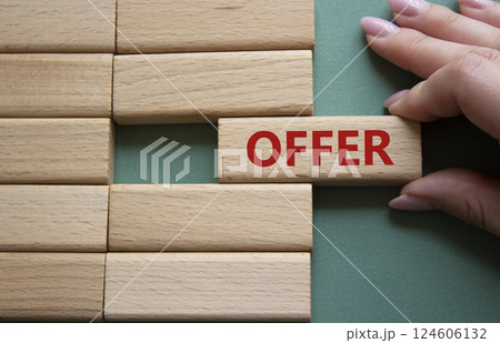 Offer symbol. Concept word offer on wooden blocks. Beautiful grey green background. Businessman hand. Business and offer concept. Copy space. 124606132