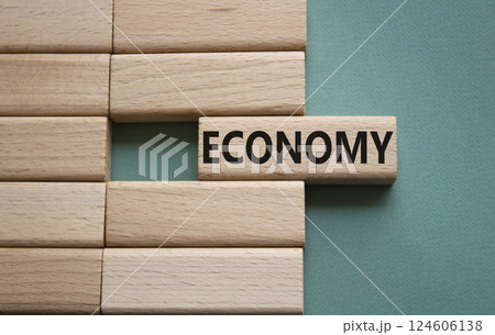 Economy symbol. Concept word Economy on wooden blocks. Beautiful grey green background. Business and Economy concept. Copy space. 124606138