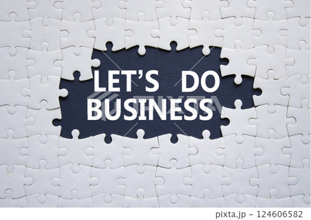 Lets do business symbol. Concept words Lets do business on white puzzle. Beautiful deep blue background. Business and Lets do business concept. Copy space. 124606582