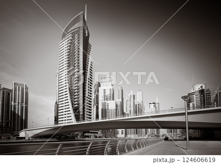 Skyscrapers and bridge over water, black and white style, city background, Dubai Marina bay UAE 124606619