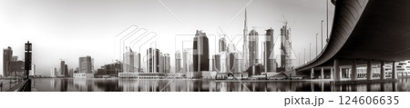 Skyscrapers and bridge over water, black and white style, city background, Dubai Marina bay UAE Skyscrapers and bridge over water, black and white style, city background, Dubai Marina bay UAE 124606635
