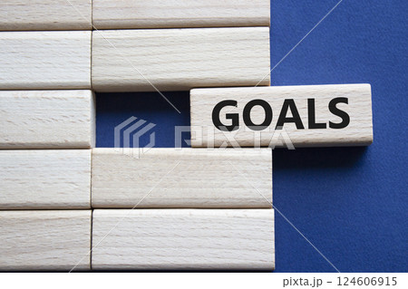 Goals symbol. Concept word Goals on wooden blocks. Beautiful deep blue background. Business and Goals concept. Copy space. 124606915
