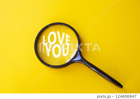 Love you symbol. Magnifying Glass with Concept word Love you. Beautiful yellow background. Love concept. Copy space Love you symbol. Magnifying Glass with Concept word Love you. Beautiful yellow background. Love concept. Copy space 124606947
