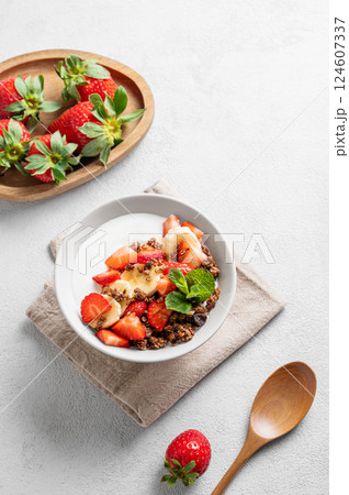 Natural Greek yogurt with homemade chocolate granola, strawberries and banana in a bowl Natural Greek yogurt with homemade chocolate granola, strawberries and banana in a bowl 124607337