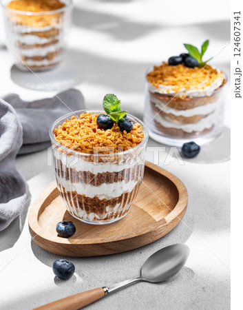 Russian honey cake Medovik trifle layered and decorated with blueberries. Sponge honey cakes 124607341