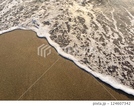 Black Sea waves and sandy beach with water during sunset or sunrise. 124607342