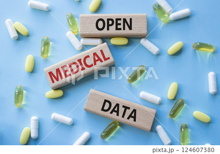 Open Medical Data symbol. Concept word Open Medical Data on wooden blocks. Beautiful blue background with pills. Medicine and Open Medical Data concept. Copy space Open Medical Data symbol. Concept word Open Medical Data on wooden blocks. Beautiful blue background with pills. Medicine and Open Medical Data concept. Copy space 124607380