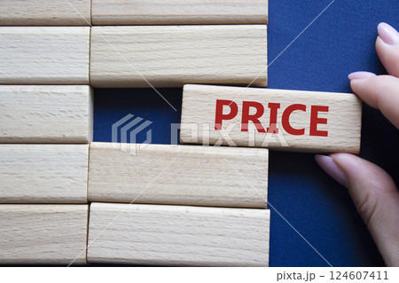 Price symbol. Concept word Price on wooden blocks. Beautiful deep blue background. Businessman hand. Business and Price concept. Copy space. Price symbol. Concept word Price on wooden blocks. Beautiful deep blue background. Businessman hand. Business and Price concept. Copy space. 124607411