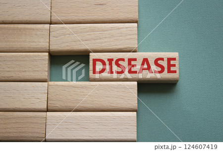 Disease symbol. Concept word Disease on wooden blocks. Beautiful grey green background. Medicine and Disease concept. Copy space. Disease symbol. Concept word Disease on wooden blocks. Beautiful grey green background. Medicine and Disease concept. Copy space. 124607419