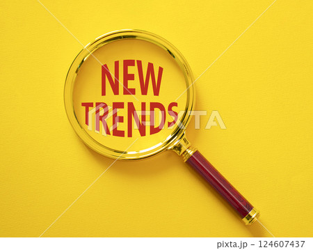 New Trends symbol. Magnifying glass with words New Trends. Beautiful yellow background. Business and New Trends concept. Copy space. New Trends symbol. Magnifying glass with words New Trends. Beautiful yellow background. Business and New Trends concept. Copy space. 124607437